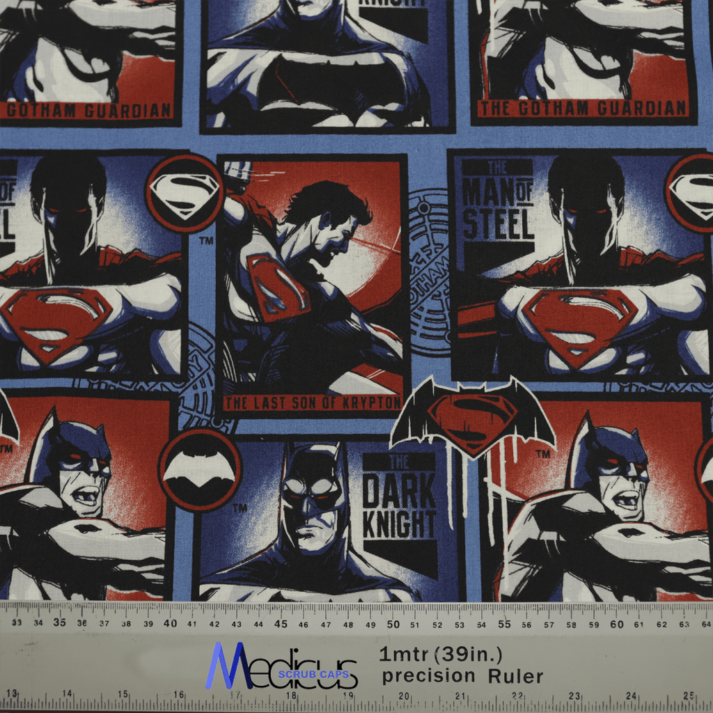 The Superman vs Batman #2 Scrub Cap by Medicus Scrub Caps is made from sustainable fabric and features stylized comic panels of The Last Son of Krypton and The Dark Knight. It showcases a dynamic clash in blue, red, and black with a ruler at the bottom for scale.