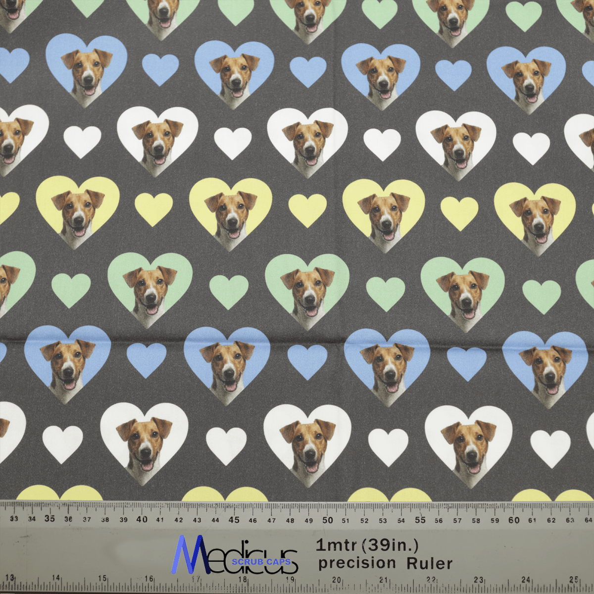 The Sweetheart Jack Russell Dogs Hearts Scrub Cap from Medicus Scrub Caps features Jack Russell faces in colorful heart shapes on a dark background, with a measurement ruler below.