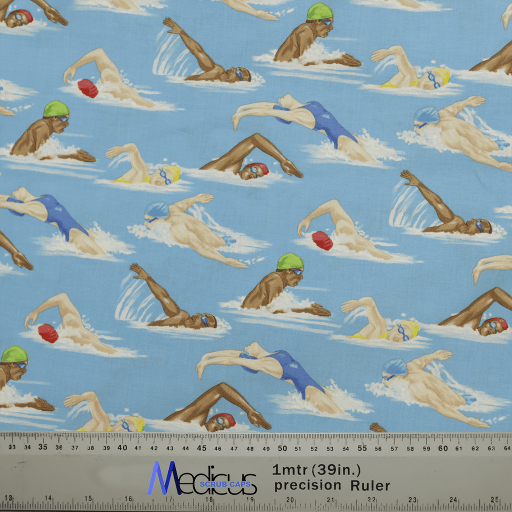 The Swimmers Scrub Cap from Medicus Scrub Caps features patterned fabric with swimmers in various strokes on a blue background, showcasing people in swim caps and goggles. Its ideal for crafting stylish scrub caps for healthcare professionals, with a measuring ruler visible in the image.