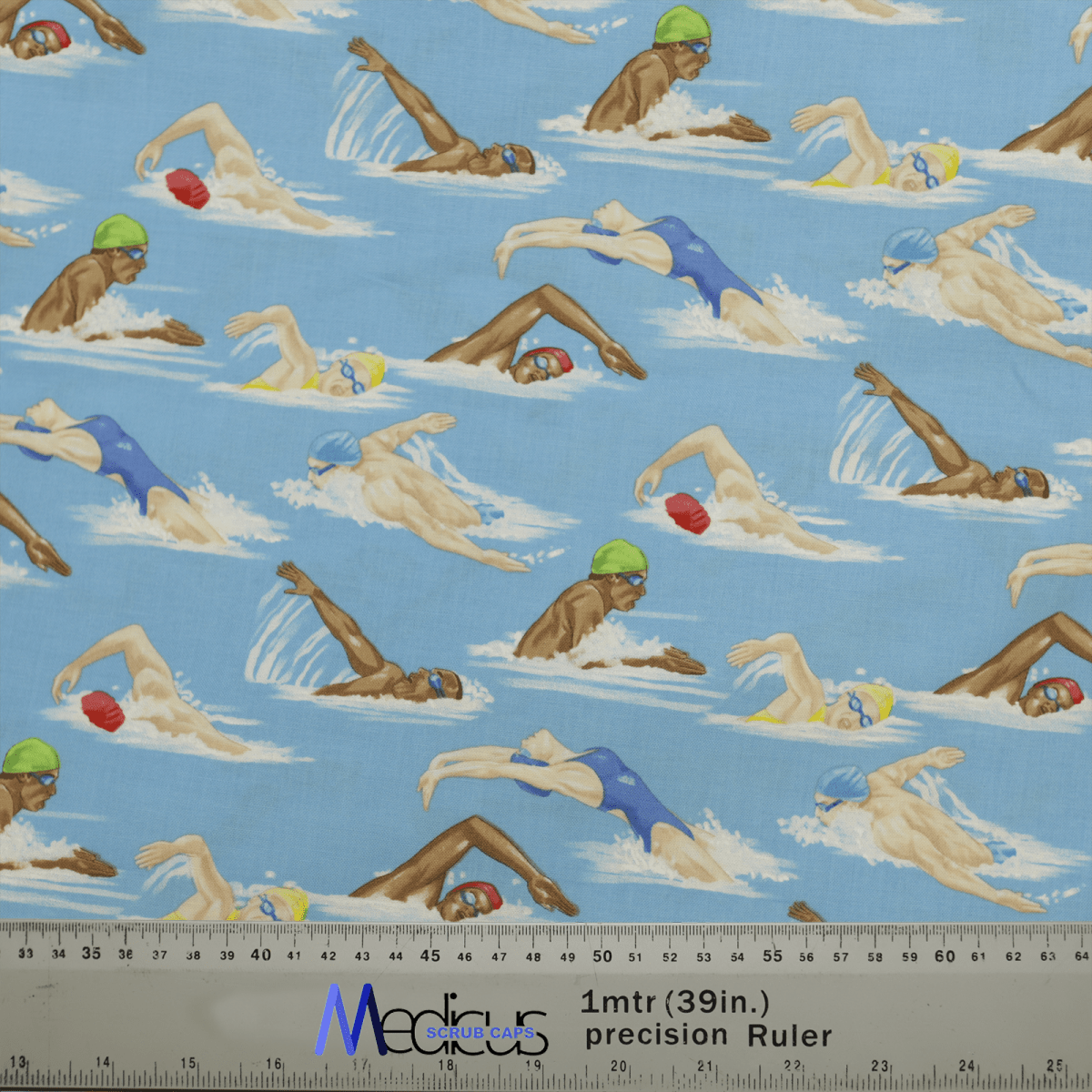 The Swimmers Scrub Cap from Medicus Scrub Caps features patterned fabric with swimmers in various strokes on a blue background, showcasing people in swim caps and goggles. Its ideal for crafting stylish scrub caps for healthcare professionals, with a measuring ruler visible in the image.