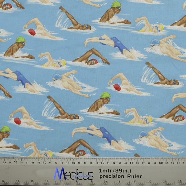 The Swimmers Scrub Cap from Medicus Scrub Caps features patterned fabric with swimmers in various strokes on a blue background, showcasing people in swim caps and goggles. Its ideal for crafting stylish scrub caps for healthcare professionals, with a measuring ruler visible in the image.