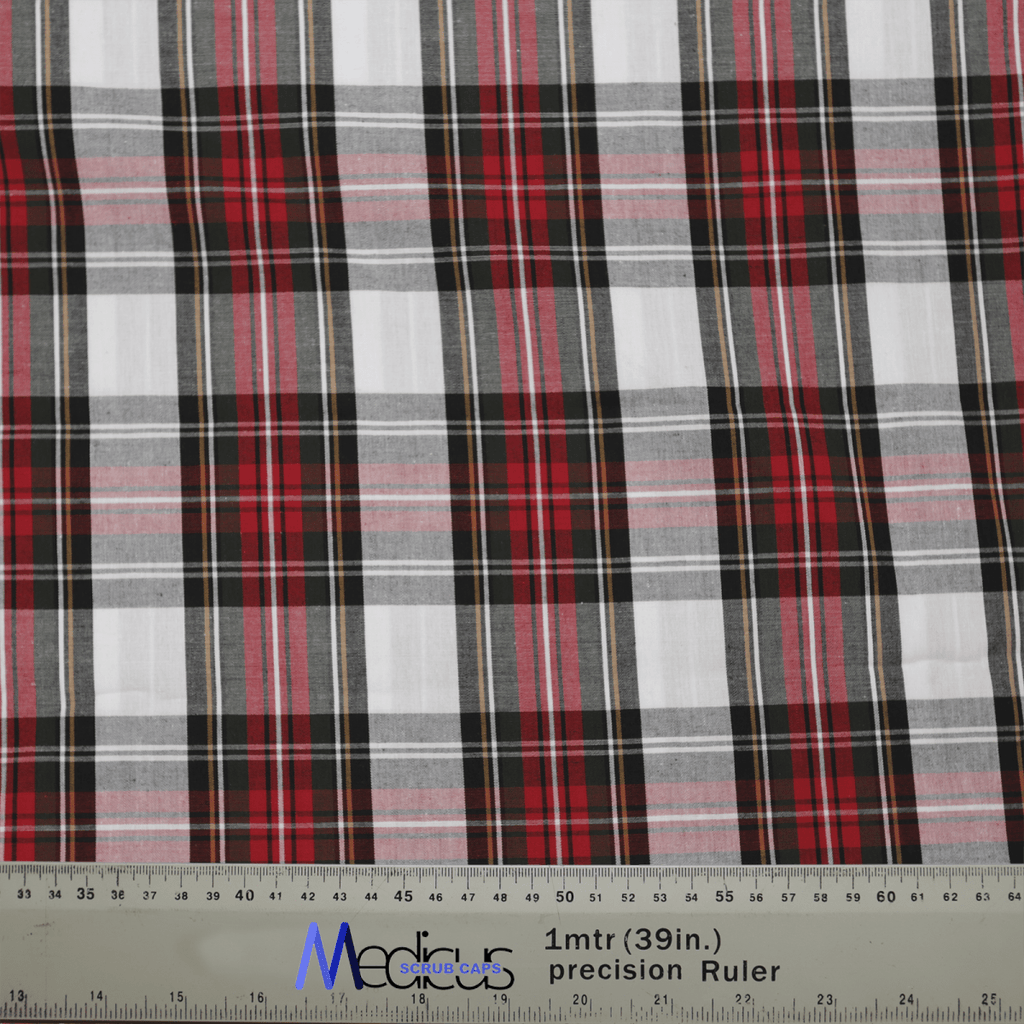 A close-up of Medicus Scrub Caps Tartan Red White Scrub Cap, featuring red, black, and white tartan fabric for a distinctive style preferred by healthcare professionals. A ruler along the bottom edge shows measurements in centimeters and inches.