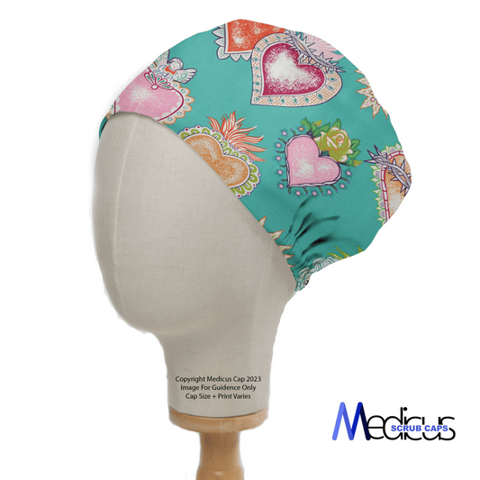 A mannequin head showcases the Tattoo #1 Love Hearts Scrub Cap from Medicus Scrub Caps, featuring vibrant heart and floral tattoo-style patterns in turquoise. The logo at the bottom right highlights its comfortable, functional, and sustainable design.