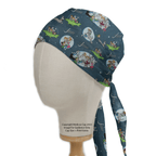 A mannequin head displays The Jetsons Family Scrub Cap by Medicus Scrub Caps, combining retro-futuristic style with a playful space theme. It features characters and spaceships on dark blue fabric, with a reusable tie-back design and copyright details included.