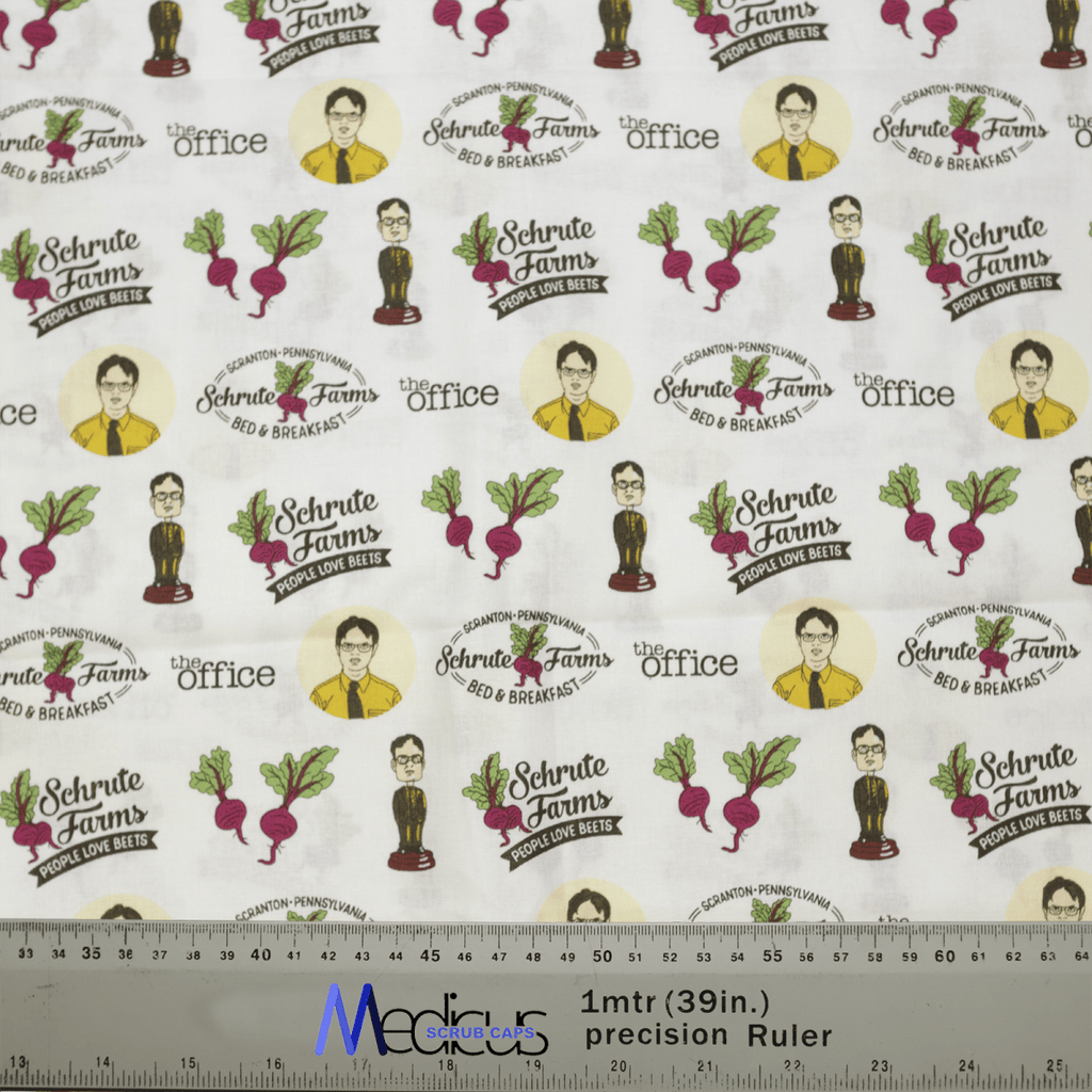 The The Office Schrute Farms Scrub Cap by Medicus Scrub Caps features cartoon characters in suits, beets, and text like “Schrute Farms Bed & Breakfast” and “The Office,” ideal for Healthcare Style enthusiasts. A ruler displays scale at the bottom.