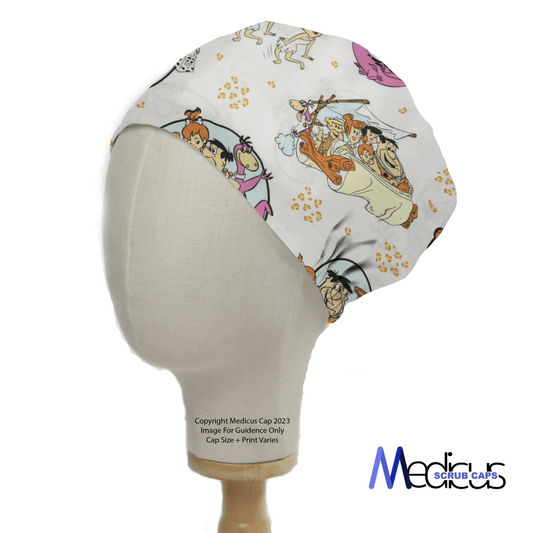 A mannequin head displays the TV Cartoon Flintstones Bedrock Car Scrub Cap by Medicus Scrub Caps, with colorful characters in a Flintstones car on a white background. The Medicus Scrub Caps logo is at the bottom right, adding fun flair to your healthcare workwear.