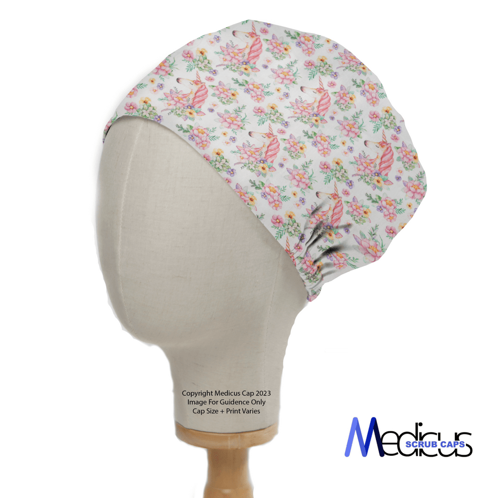 A side view of a mannequin head showcases the Unicorns Flower Power Scrub Cap, adorned with whimsical floral and ribbon patterns. The snug fit reveals an elastic section at the back, with Medicus Scrub Caps text at the bottom right.