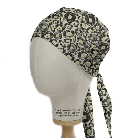 Adorned with a vibrant record pattern, the Medicus Scrub Caps Vinyl Discs Scrub Cap is ideal for music enthusiasts. Displayed on a mannequin, it adds rhythmic flair to eco-friendly healthcare attire.