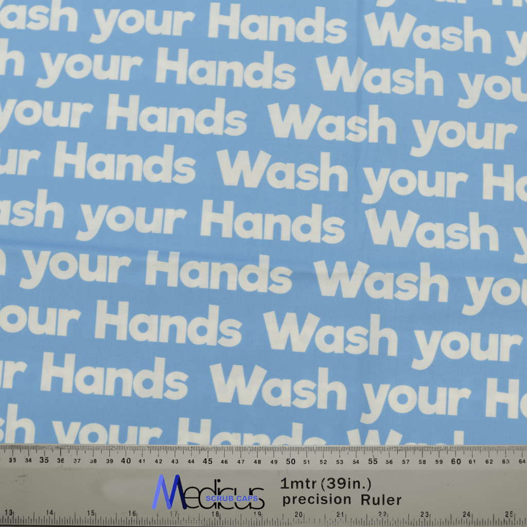 The blue Wash Your Hands scrub cap, featuring repeated white text, is perfect for a sustainable healthcare environment. Its ideal for crafting with accurate measurements shown by a ruler at the bottom edge. Made by Medicus Scrub Caps.