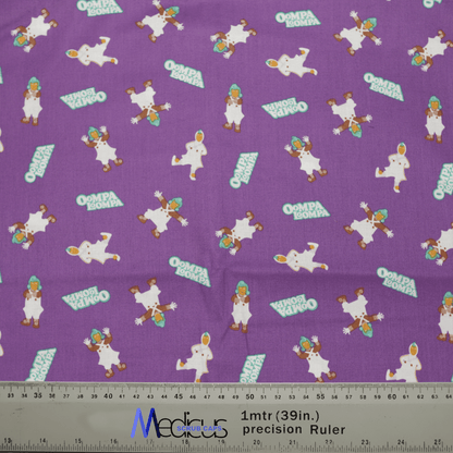 The Medicus Scrub Caps Willy Wonka Oompa Loompa features colorful Willy Wonka character illustrations and Ompa Loompa text on purple fabric. A ruler at the bottom highlights its whimsical design, ideal for crafting scrub caps.