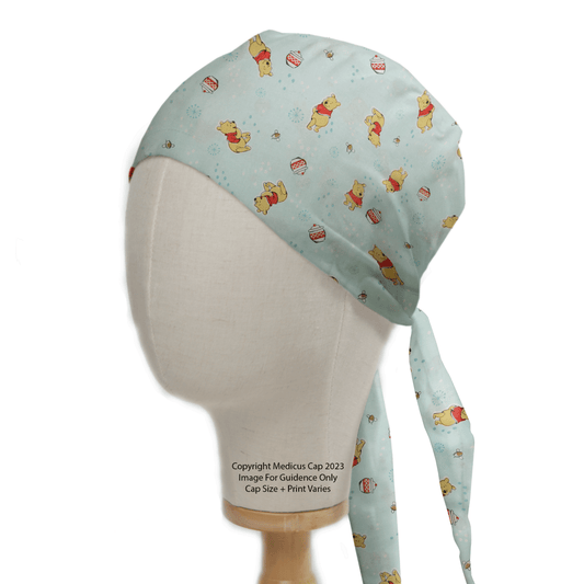 Introducing the Medicus Scrub Caps Winnie The Pooh #5 - Honey Pot Scrub Cap, ideal for healthcare professionals. Featuring cartoon bear and honey pot designs on light blue with tie strings, it highlights our dedication to sustainable, eco-friendly materials. Model pictured is for illustration only.