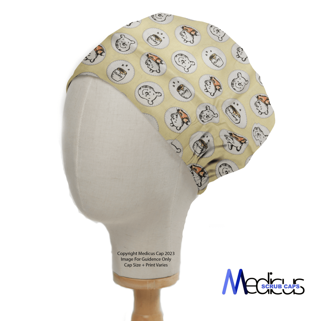 A mannequin head wears the Winnie the Pooh Honey Pots Scrub Cap by Medicus Scrub Caps, featuring cartoon animals like white bears and orange-striped tigers. Set against a plain white backdrop, this delightful cap is ideal for healthcare professionals.