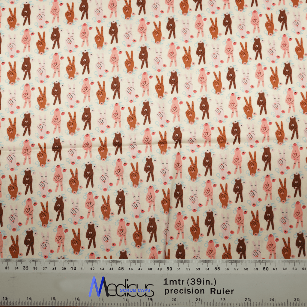 Medicus Scrub Caps offers the Women Peace Sign Empowerment Scrub Cap, featuring a repeated pattern of brown, pink, and white standing rabbits with spots or hearts in various poses. Ideal for healthcare professionals, it includes a measuring ruler at the bottom to show scale.